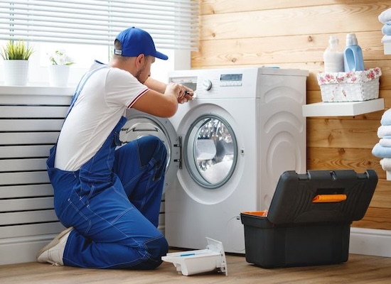 Technician repairing washing machine in Kochi